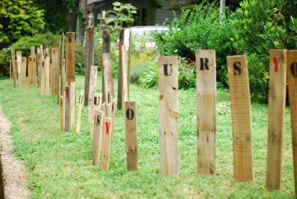 Original art created by Laurie Smithwick (and family) for Yard Art Day in Charlotte, NC. The piece is a riff on the picket fence that doesn't actually keep anyone out, called "What's (Y)Ours is..."