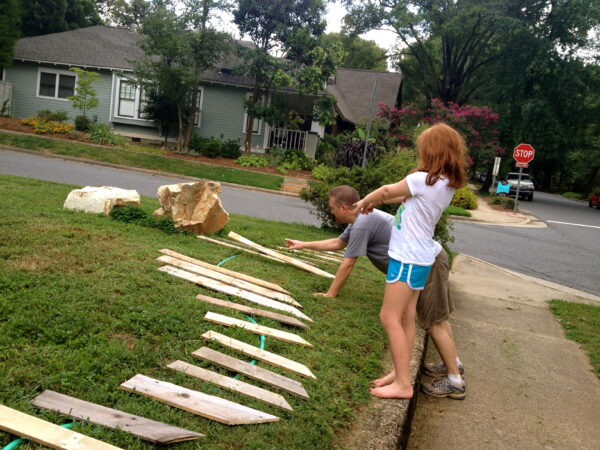 Original art created by Laurie Smithwick (and family) for Yard Art Day in Charlotte, NC. The piece is a riff on the picket fence that doesn't actually keep anyone out, called "What's (Y)Ours is..."