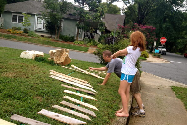 Original art created by Laurie Smithwick (and family) for Yard Art Day in Charlotte, NC. The piece is a riff on the picket fence that doesn't actually keep anyone out, called "What's (Y)Ours is..."
