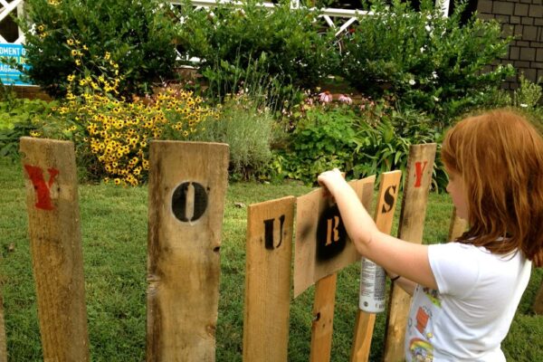Original art created by Laurie Smithwick (and family) for Yard Art Day in Charlotte, NC. The piece is a riff on the picket fence that doesn't actually keep anyone out, called "What's (Y)Ours is..."