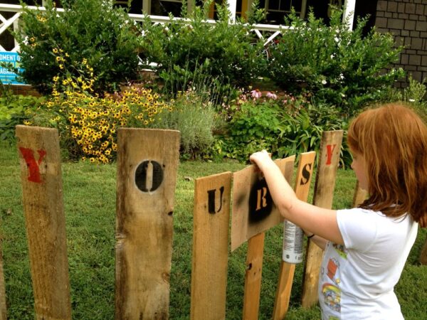 Original art created by Laurie Smithwick (and family) for Yard Art Day in Charlotte, NC. The piece is a riff on the picket fence that doesn't actually keep anyone out, called "What's (Y)Ours is..."
