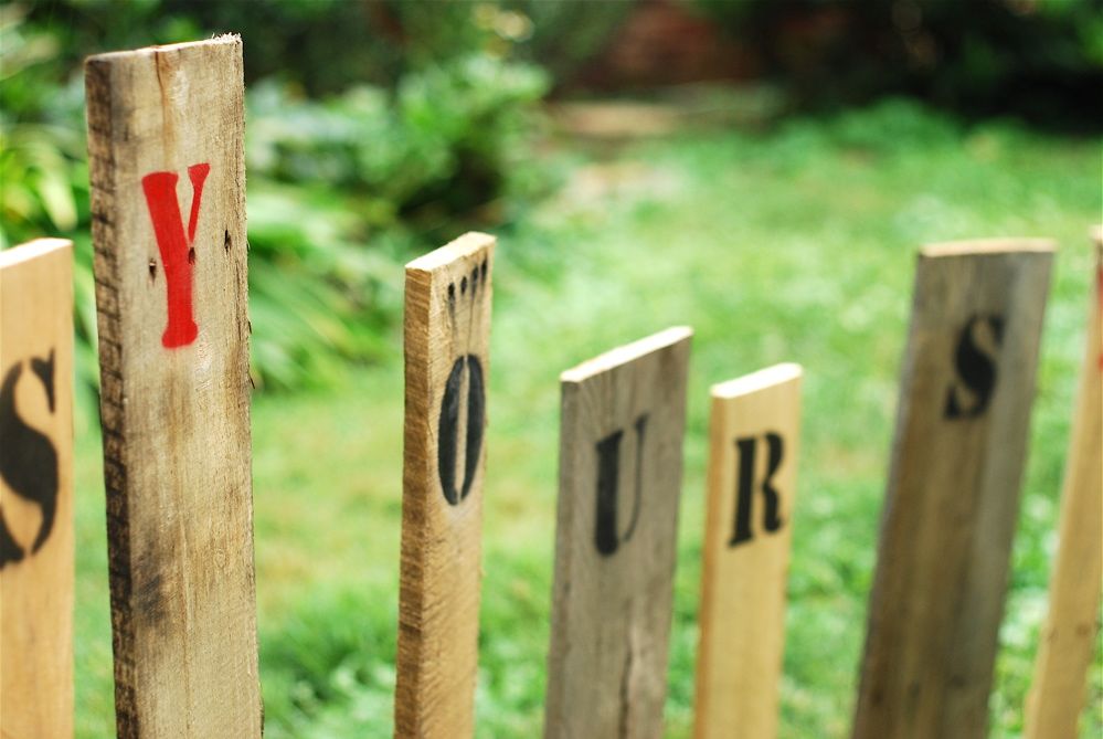 Original art created by Laurie Smithwick (and family) for Yard Art Day in Charlotte, NC. The piece is a riff on the picket fence that doesn't actually keep anyone out, called "What's (Y)Ours is..."