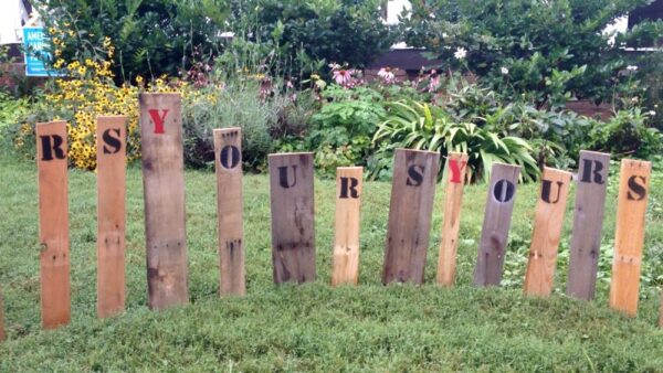 Original art created by Laurie Smithwick (and family) for Yard Art Day in Charlotte, NC. The piece is a riff on the picket fence that doesn't actually keep anyone out, called "What's (Y)Ours is..."